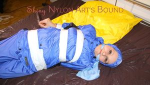 Lucy taped, hooded and gagged on bed wearing sexy blue rainwear (Pics)