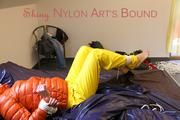 Pia tied and gagged on bed wearing a yellow rain pants and an orange downjacket (Pics)