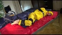 Sonja tied, gagged and hooded on bed with tape wearing a supersexy yellow rainwear combination (Video)