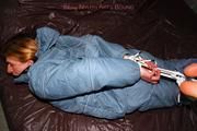 Katharina tied and gagged in a blue skisuit