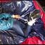 Lulu tied and gagged on a bed wearing a supersexy blue/green rainwear combination (Video)
