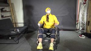 Watch Marie bound to a Wheelchair and tightly gagged in shiny nylon Rainwear