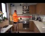 Sonja cleaning up the kitchen wearing a sexy black shiny nylon shorts and an orange rain jacket (Video)