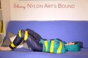 Mara tied and gagged with tape on a sofa wearing a supersexy shiny blue rain pants and a grren rain jacket (Pics) 