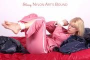 Pia tied and gagged in a beautiful rose shiny nylon rainsuit in bed (Pics)