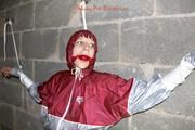 Nicole tied and gagged by Sophie in an red/silver PVC rainsuit in the cellar