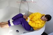 Julia tied and gagged in a ski suit in the bath tub
