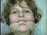 19 Yr OLD SINGLE MOM RONI IS WRAP CLEAVE GAGGED WITH AN ACE BANDAGE, HANDGAGGED, MOUTH STUFFED, BALL-GAGGED & TIED BACKWARDS TO A CHAIR (D53-9)