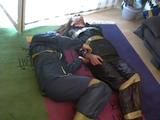 Two archive girls tied and gagged with tape on the floor wearing shiny nylon rainwear (Video)