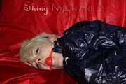 Sexy Courtney being tied and gagged with ropes and a ballgag on a bed wearing dark blue rainwear (Pics)