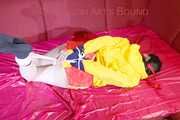 ***LUCIE*** wearing red/yellow shiny nylon shorts and a yellow shiny nylon rain jacket being bound on a sofa with ropes and a ball gag (Pics)