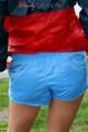 Sexy archive girl walking on a lake wearing a sexy shiny nylon shorts and an oldschool rain jacket (Pics)