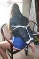 Stella being tied and gagged with ropes and a clothgag on a chair wearing a sexy shiny nylon short and a rain jacket (Pics)