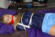 Samantha tied and gagged wearing a beautiful lightblue nylon shorts and a darkblue rain jacket (Pics)