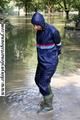 Stella bound outdoor in a blue rainsuit