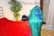Lucy putting on linen on bed wearing supersexy green shiny nylon rainwear (Pics)