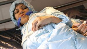 Lulu tied and gagged on a bed wearing a supersexy lightblue shiny nylon downjacket and a blue rain pants (Pics)