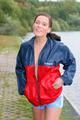 Sexy archive girl walking on a lake wearing a sexy shiny nylon shorts and an oldschool rain jacket (Pics)