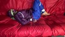 SANDRA being tied and gagged on a sofa with ropes and a clothgag wearing a sexy blue shiny nylon rain pants and a purple rain jacket  (Video)
