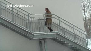 020167 Kathy Pees From A Staircase In The Snow