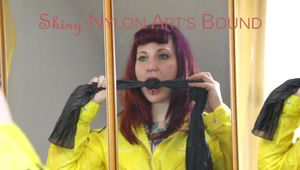 Mara ties and gagges herself with hand cuffs on bed wearing a hot black shiny nylon shorts (Pics)