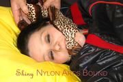 Lucy tied and gagged in a bed wearing a black shiny nylon downwear combination (Pics)