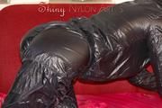 Lucy wearing a very hot black rainwear combination lolling and posing on a sofa (Pics)