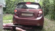 Mistress Jenna stands on the slave with a car while smoking in the slave's mouth A