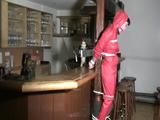 one of our archive girl tied and gagged in a shiny nylon rainsuit