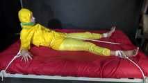 Watching sexy Pia being tied and gagged with ropes on a bed and a clothgag wearing sexy yellow shiny nylon rainwear (Video)