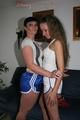 Jill and Petra touching eachother in front of a sofa wearing sexy shiny nylon shorts (Pics)