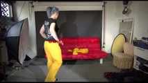 Watching Mara putting on sexy yellow shiny nylon rainwear lolling on the sofa (Video)