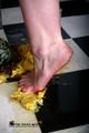 Heels crushing pineapple in the kitchen