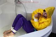 Julia tied and gagged in a ski suit in the bath tub