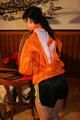 Jill wearing a sexy black nylon shorts and a orange rain jacket while dressing her up (Pics)