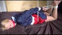 ***HOT HOT HOT*** PIA tied and gagged on a bed with ropes on the ceiling wearing sexy blue/red shiny nylon shorts and a white shirt (Video)
