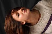 Barefoot Gwen in sweater and short skirt, suspended sideways with violet hemp rope, dangles in the air