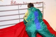 Lucy putting on linen on bed wearing supersexy green shiny nylon rainwear (Pics)