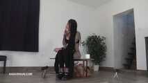Mistress Cleo squirts cologne into the mouth of the slave lying in the toilet.