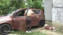 Mistress Jenna stands on the slave with a car while smoking in the slave's mouth A