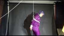 MARA tied and gagged overhead with ropes and a cloth gag wearing a super sexy super shiny purple rainsuit and blue rubber boots (Video)