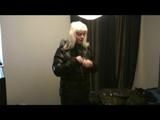 Blonde-haired archive girl going out wearing shiny nylon rainwear (Video)