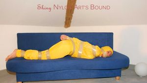 Archive girl tied and gagged by using tape on a sofa wearing an yellow rainsuit (Pics)