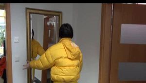 Jill wearing a yellow rain pants down jacket combination and rubber boots at home and outdoor (Video)