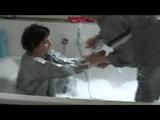 Simone  with an shiny silver PVC sauna suit tied and gagged by Sophie in an bath tub (Video)
