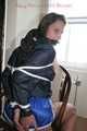Stella being tied and gagged with ropes and a clothgag on a chair wearing a sexy shiny nylon short and a rain jacket (Pics)