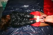 Alina tied and gagged in red nylon shorts and a shiny black jacket