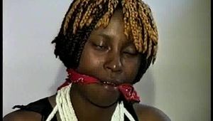 21 Yr OLD BLACK COLLEGE STUDENT GETS MOUTH STUFFED, WRAP TAPE GAGGED WHILE TIED TO A CHAIR  WEARING BLACK LINGERIE, GARTER BELT & HIGH HEELS (D65-4)