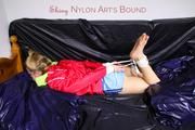 Samantha tied and gagged in a shiny light blue nylon shorts and a red shiny rainjacket (Pics) 