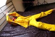 Pia tied and gagged in a shiny nylon rainsuit 